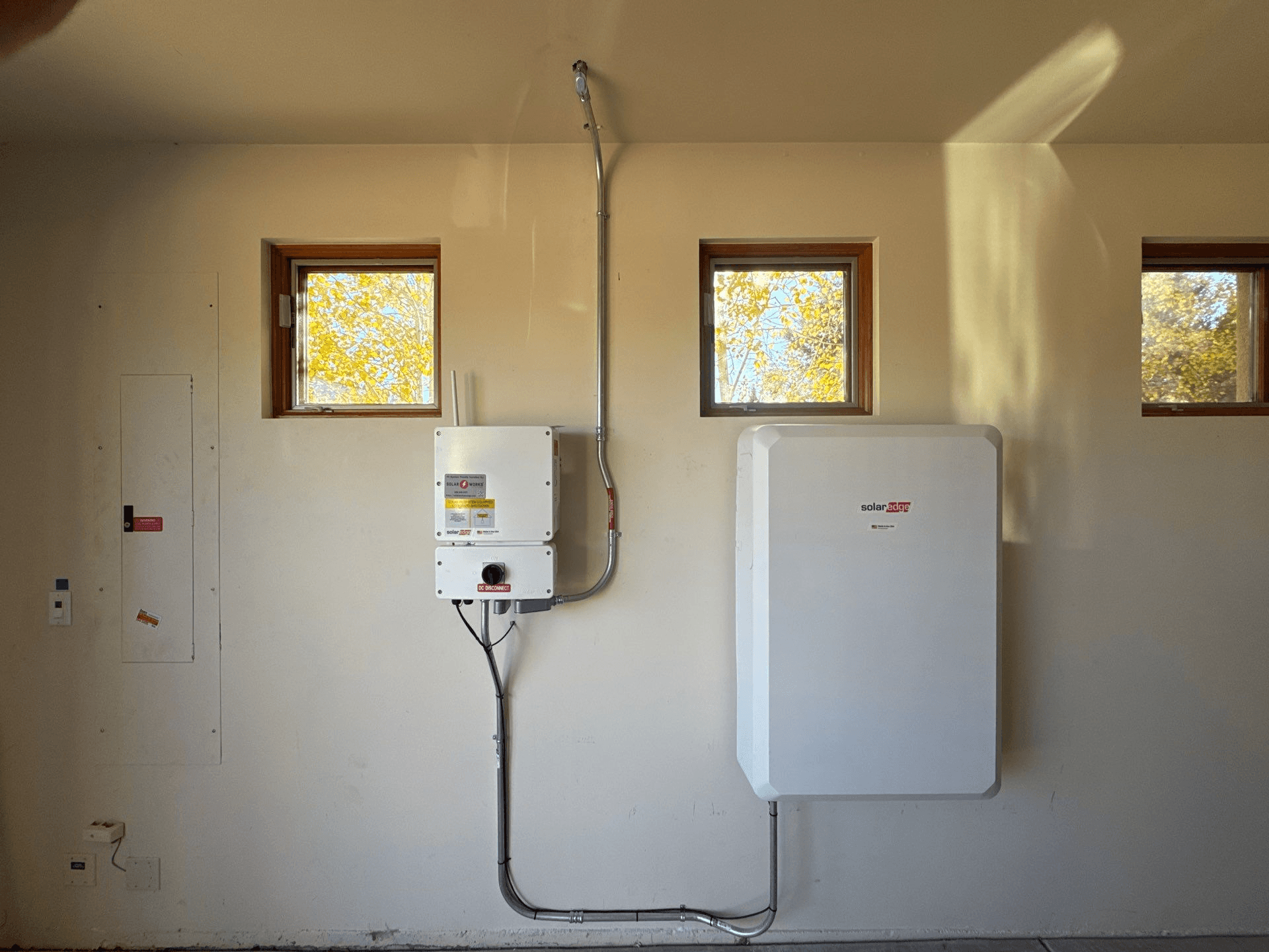 Home battery, inverter, and electrical panel mounted on a wall — a complete Epex install