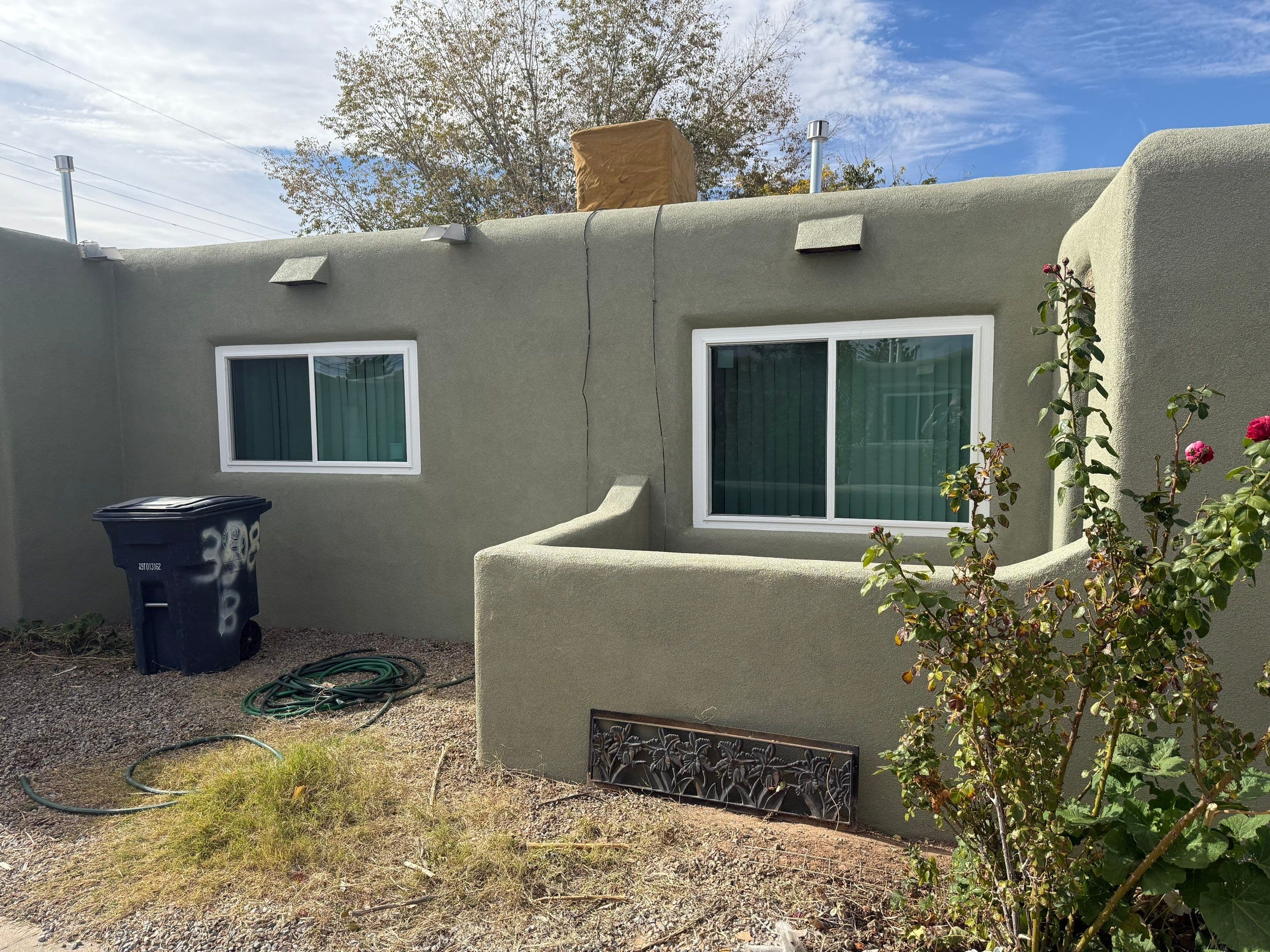 Side elevation of the same home showing two of the new replacement windows from a different angle